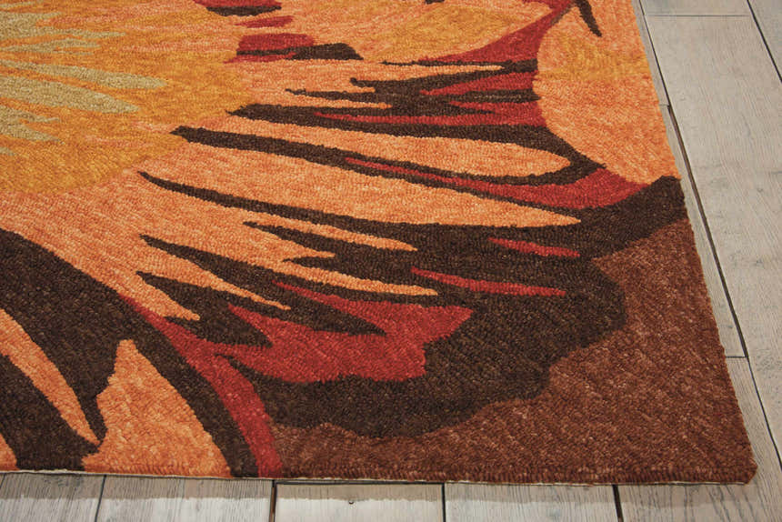 Close up of the multicolor Nourison South Beach rug, featuring orange, brown, and red floral design.