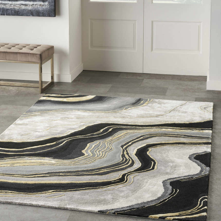 Entryway with a taupe bench and Nourison Prismatic Charcoal Grey area rug with a modern, abstract design.