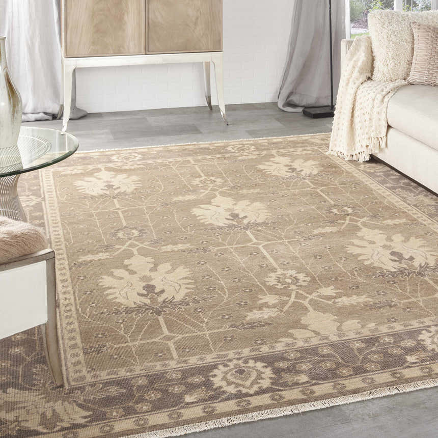 Living room scene with a Nourison Aldora Opal Grey vintage rug, sofa, glass table, and neutral decor.