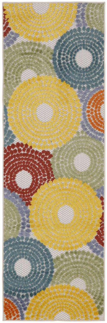 Close-up of the Nourison Aloha Multicolor Area Rug, featuring a circular mid-century modern design in yellow, blue, green, and red.