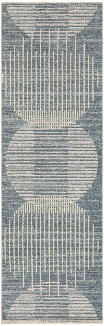 Close-up of the Nourison Astra rug. Light blue rug with a mid-century modern geometric pattern of circles and lines.