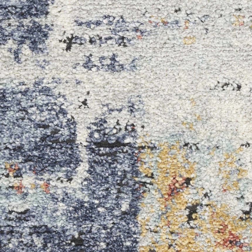 Close-up of Nourison Motion Blue Multicolor rug showing low pile texture and abstract blue, gold, and cream pattern.