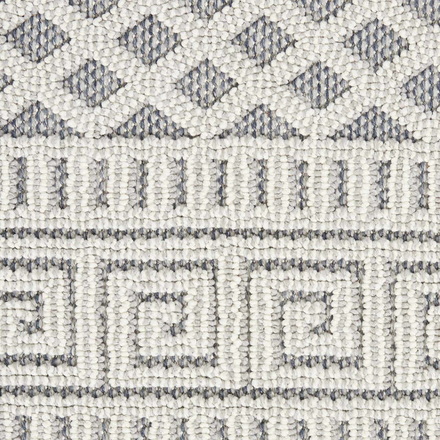 Close-up of the Nourison Paxton Ivory/Slate rug showing its geometric, textured design and neutral colors.