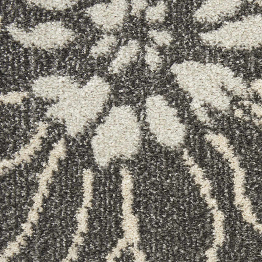 Close up of the Nourison Passion Charcoal Blue rug showing the taupe floral and striped pattern.
