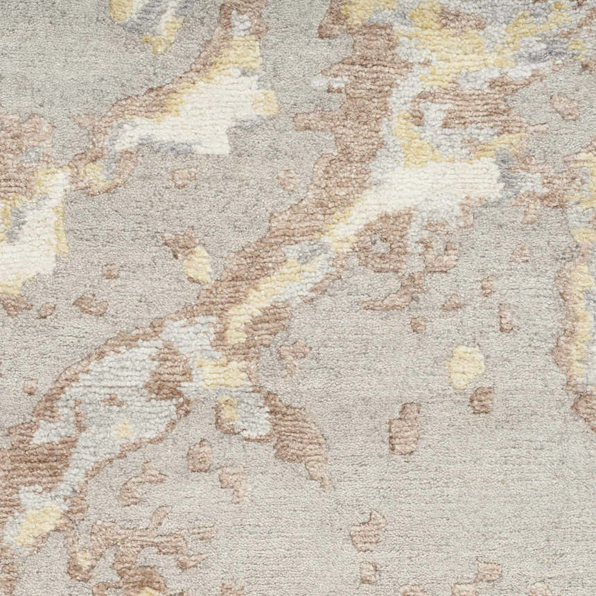 Close-up of the Nourison Silk Shadows Silver rug, showing its gray, brown, and cream abstract pattern and soft, textured pile.