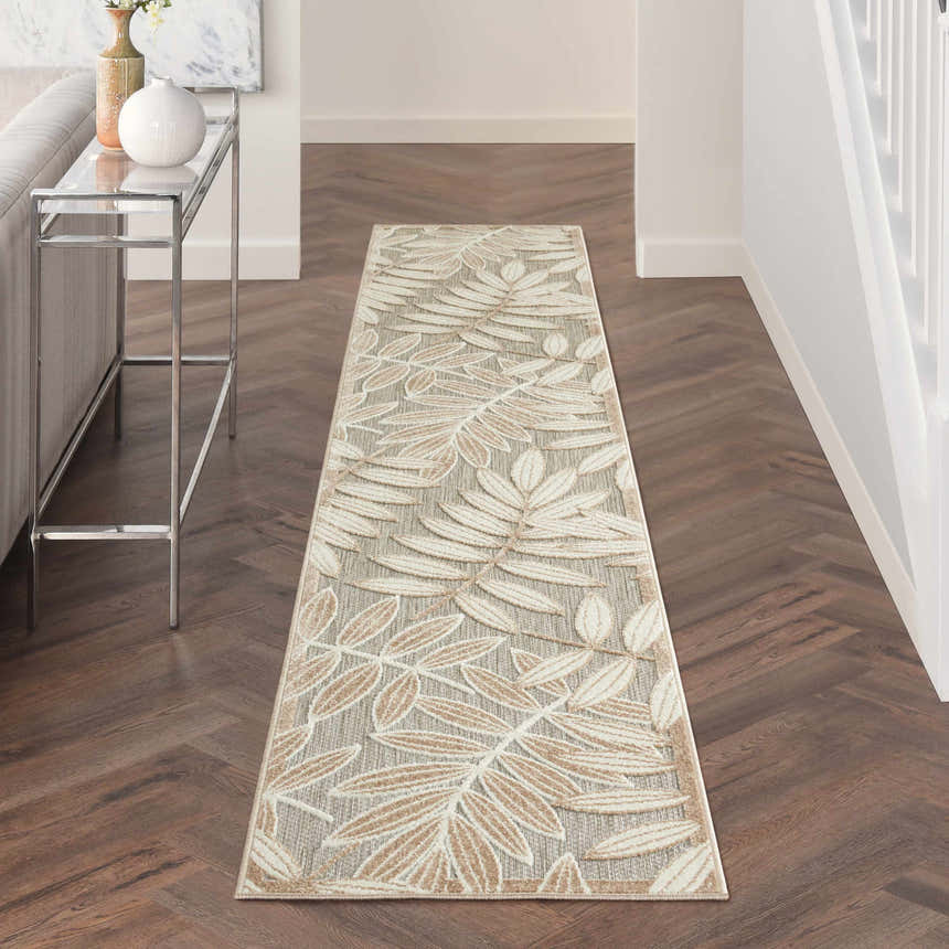 Hallway with Nourison Aloha Natural Tropical runner rug, leaf pattern, wood floors, and console table.