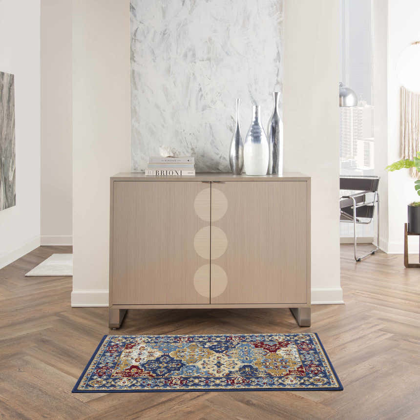 Living room scene with a Nourison Grafix Multicolor Bohemian rug, wood floors, and modern cabinet.