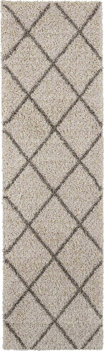 Close-up of Nourison Brisbane Cream Shag Indoor Area Rug with a diamond pattern and soft, plush texture.