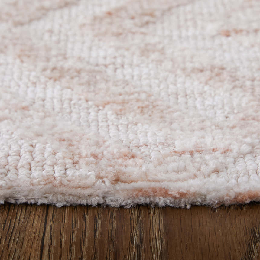 Close-up of the Feizy Colton Modern Diamond Pink/Ivory Area Rug showing its soft texture and subtle pink diamond pattern. Pile