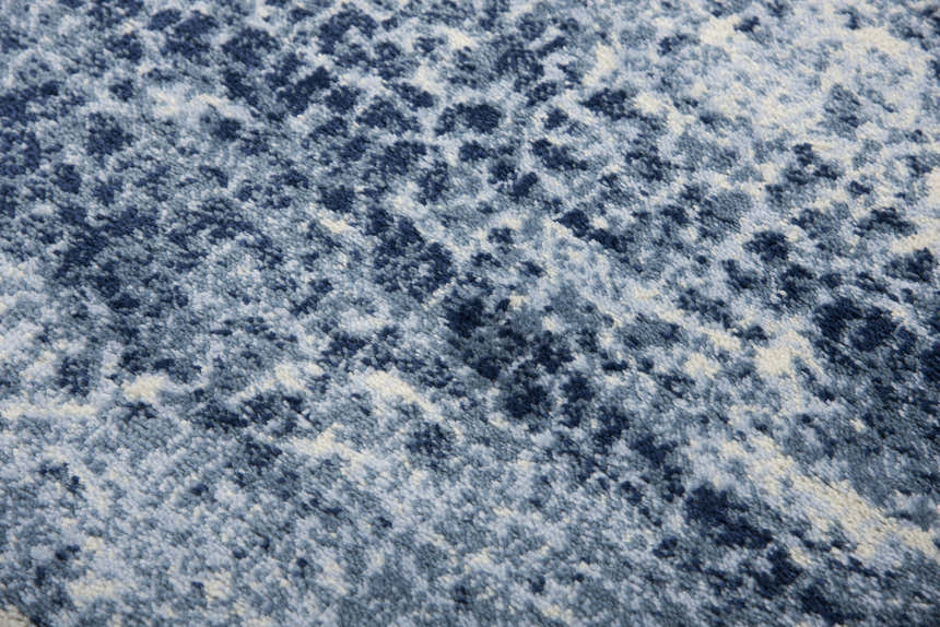 Close-up of the Rizzy EN7262 area rug. Features a contemporary blue, navy, and ivory abstract pattern. Soft texture. Texture