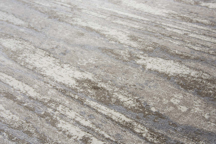 Close-up of the Rizzy EN7264 area rug showing its beige, ivory, and light brown contemporary pattern. Texture