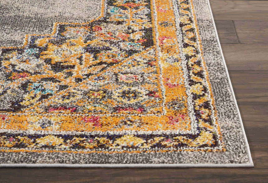 Close-up of the Nourison Passionate Grey Bohemian rug showing its gray, orange, blue, and red detailed pattern and texture.
