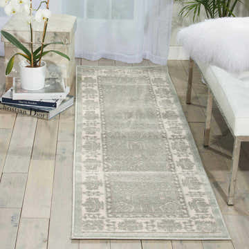 Spa-toned Nourison Euphoria Vintage runner rug in a bright room with white bench, orchid, and light wood floors.