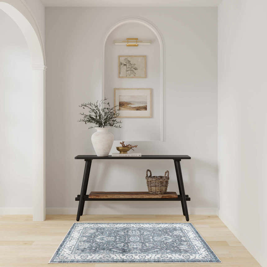 Entryway with a black console table and Nourison Astra Slate Vintage Area Rug.