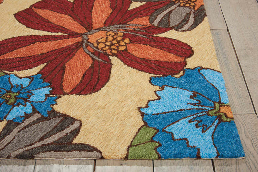 Close-up of the sandstone Nourison South Beach Area Rug with large floral pattern in blue, red, and orange.