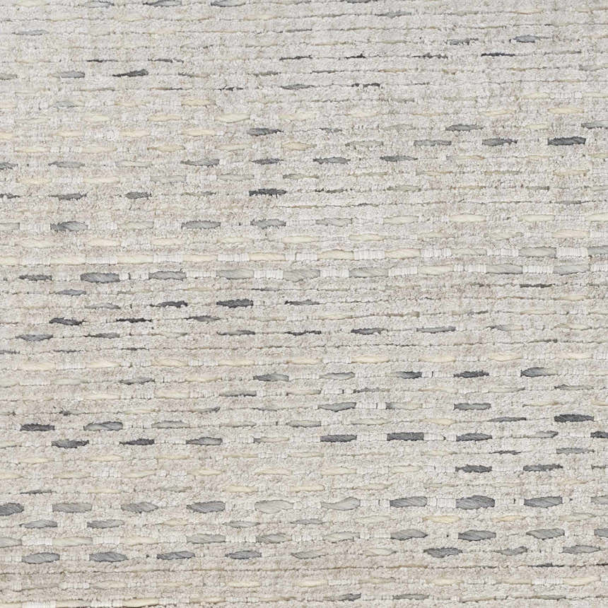 Close-up of the Calvin Klein Valley Silver rug, showing silver gray tones and a textured, handmade weave.