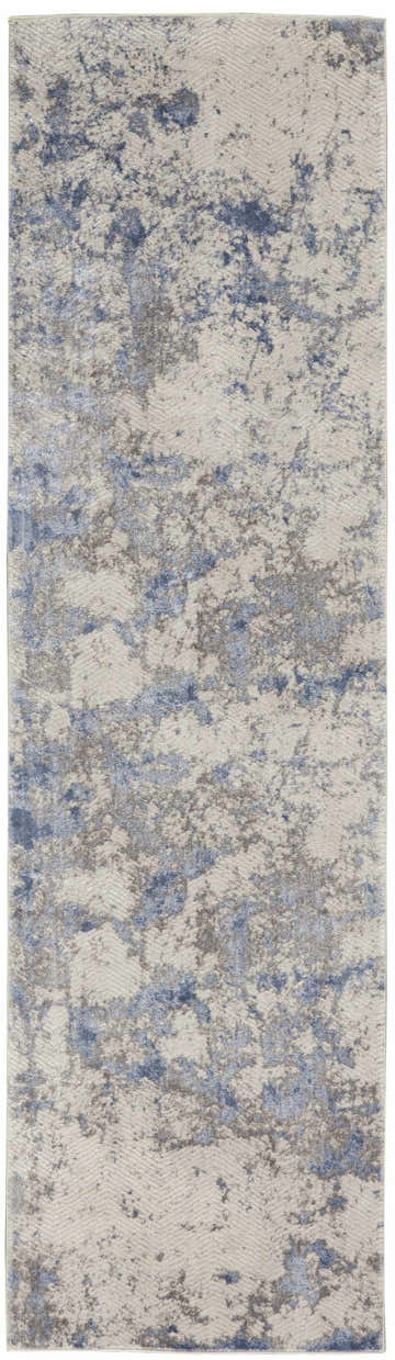 Close-up of Nourison Silky Textures Blue Ivory Grey rug. Modern design with chestnut, blue, and ivory hues.