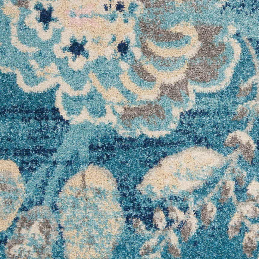 Close-up of Nourison Tranquil Turquoise Vintage rug. Aqua, beige, and gray floral pattern. Soft texture.