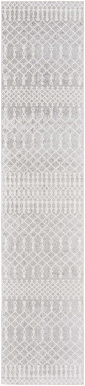 Close-up of the Nourison Astra Grey rug, showcasing its diamond and geometric bohemian pattern. Soft, neutral tones.