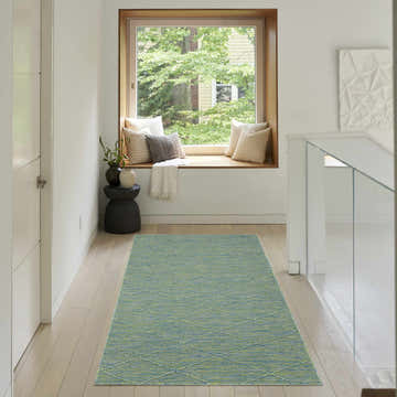 Hallway with Nourison Solutions Blue Green Modern Washable Area Rug, window seat, and light wood floors.