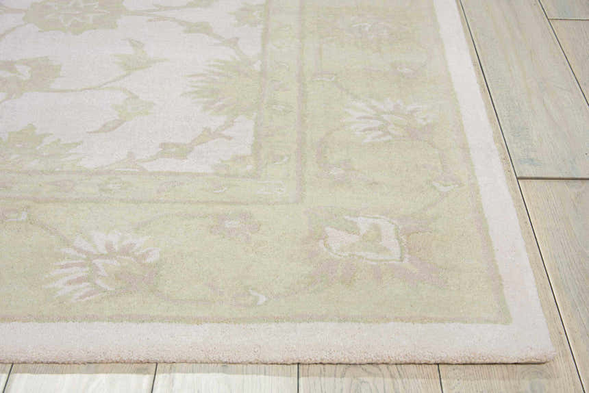 Close up of the ivory and green Nourison Zephyr rug showing floral pattern and wool texture.