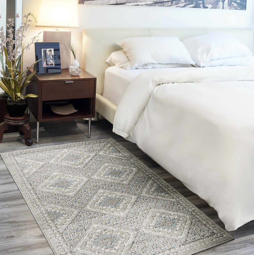 Bedroom scene with a Nourison Quarry Grey Ivory Blue Southwestern Area Rug adding subtle pattern and color to the neutral space.