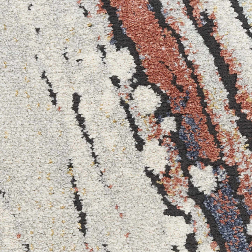 Close-up of Nourison Motion Ivory Multicolor rug showing the low pile texture and chestnut, black, and ivory hues.