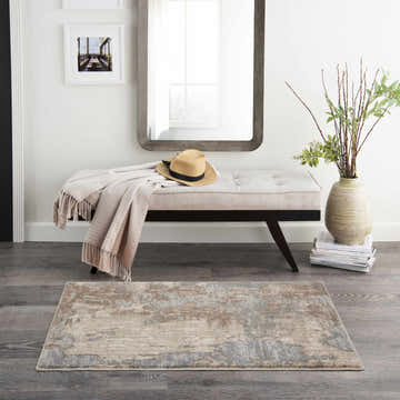 Entryway with Nourison Moroccan Celebration Grey Beige Rug, bench, mirror, and wood floors. Modern style.