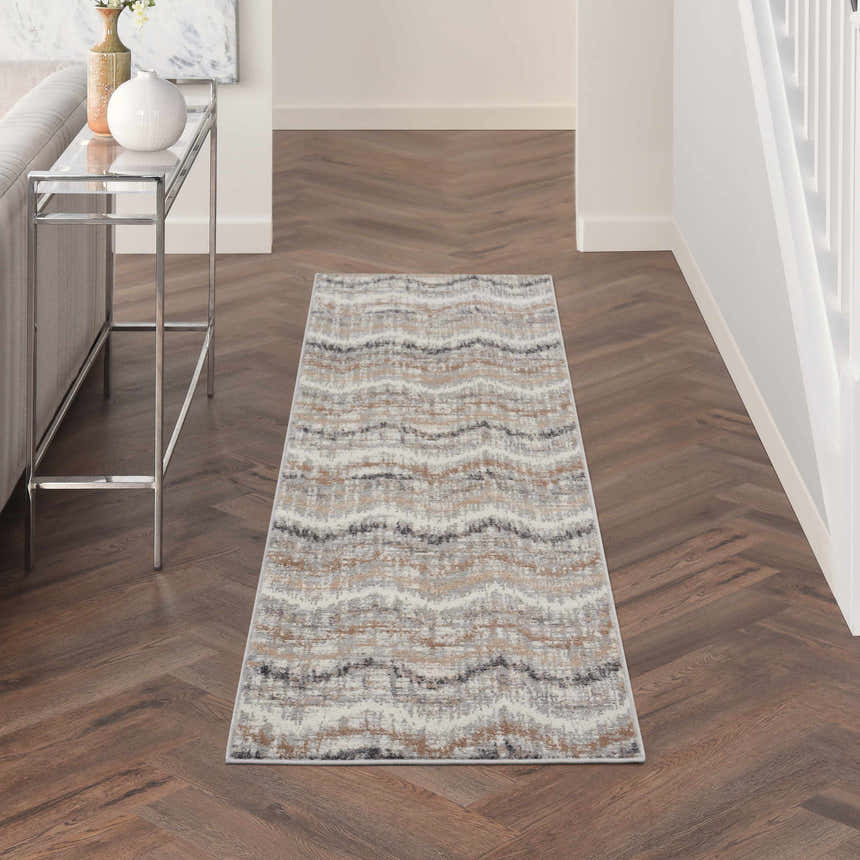 Hallway scene with a Nourison Elation Grey Ivory rug runner on herringbone wood floors. Modern console table.
