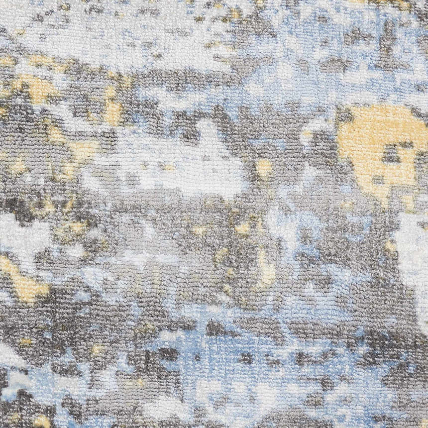 Close-up of the Nourison Safari Dreams Ivory Gold rug. Painterly design with chestnut, gold, blue, and ivory hues. Handmade texture.
