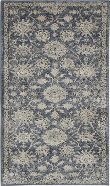 Close-up of the Nourison Quarry Blue Beige Vintage Area Rug featuring a distressed floral pattern.
