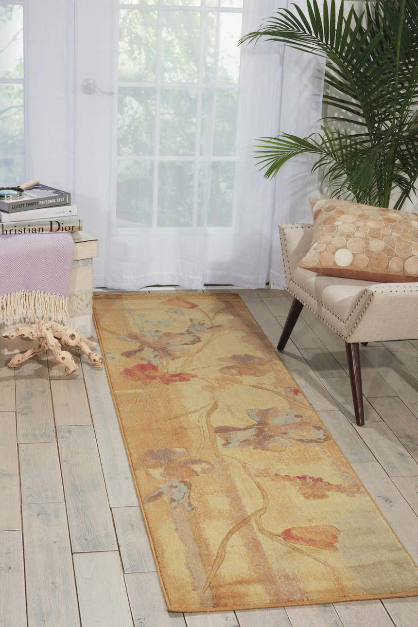 Bright room scene with Nourison Somerset Beige Farmhouse rug, accent chair, palm, and whitewashed wood floors.