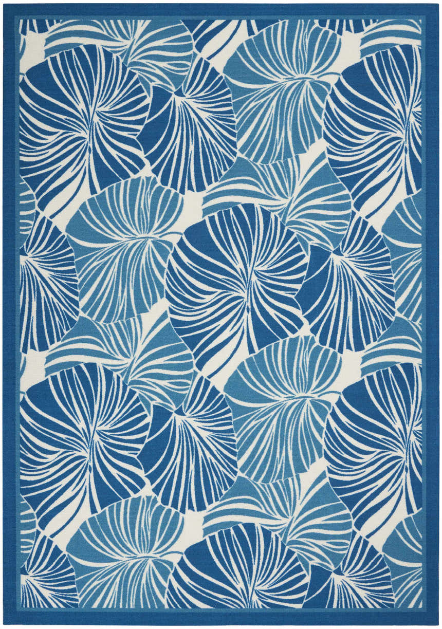 Close-up of the Waverly Sun N' Shade Blue Tropical Area Rug, featuring a light blue floral pattern on a white background.