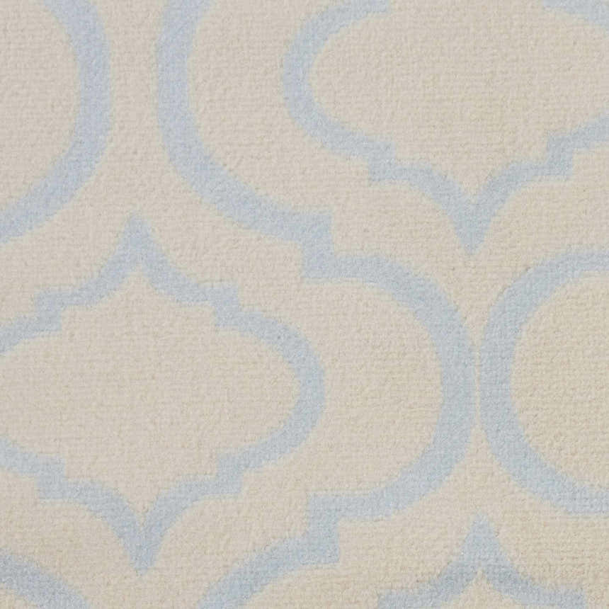 Close-up of the Nourison Jubilant Ivory Blue rug, showcasing its contemporary quatrefoil pattern and soft, textured weave.