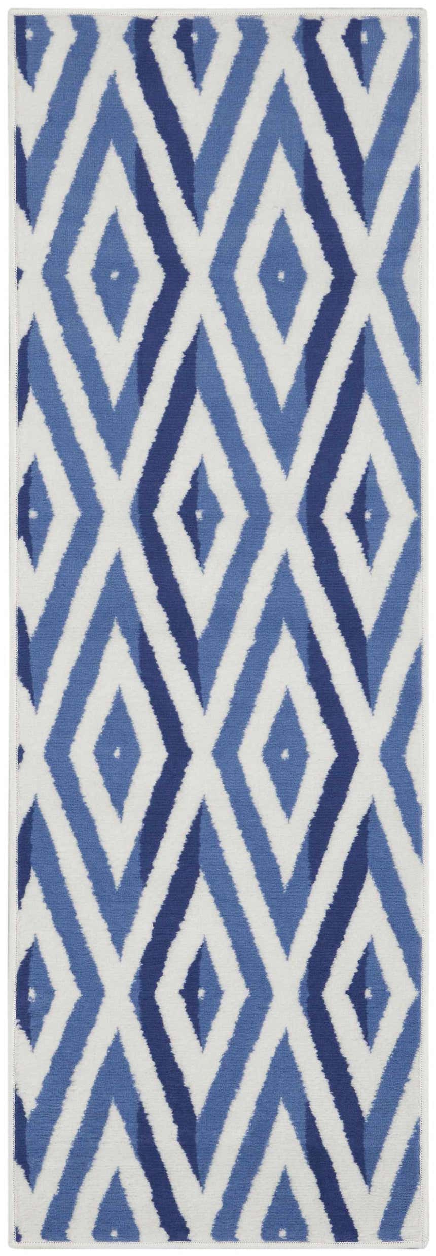Close-up of the Nourison Whimsicle Ivory Blue rug. Features a modern diamond pattern in shades of blue on an ivory background.
