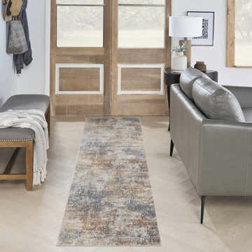 Entryway with a gray leather sofa and Nourison Astra Multicolor Modern rug runner.