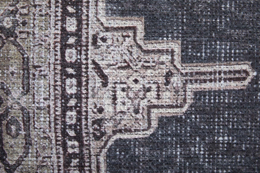 Close up of Feizy Percy rug showing gray, ivory, and taupe medallion pattern and woven texture. Texture