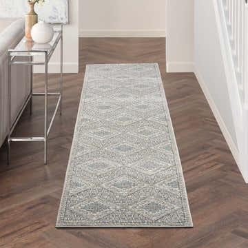 Hallway with Nourison Quarry Grey Ivory Blue Southwestern Runner Rug on dark wood floors.