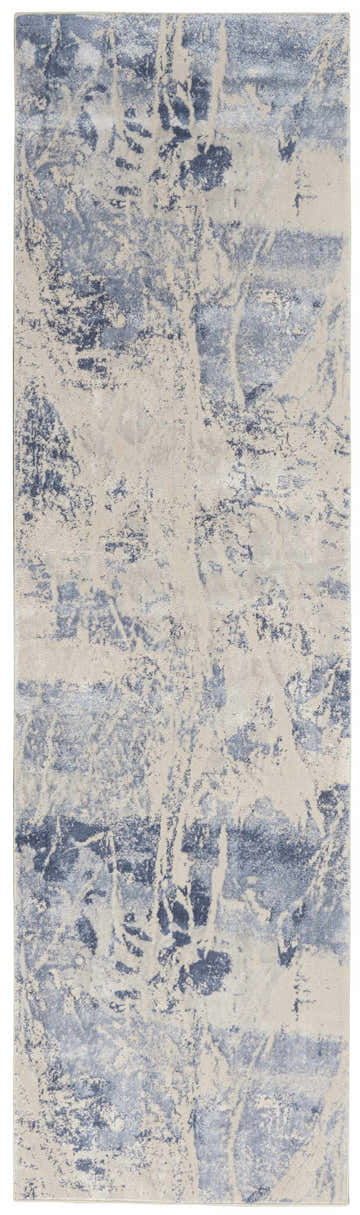 Close-up of the Nourison Silky Textures Blue Cream rug, featuring a modern abstract pattern and soft, silky texture.