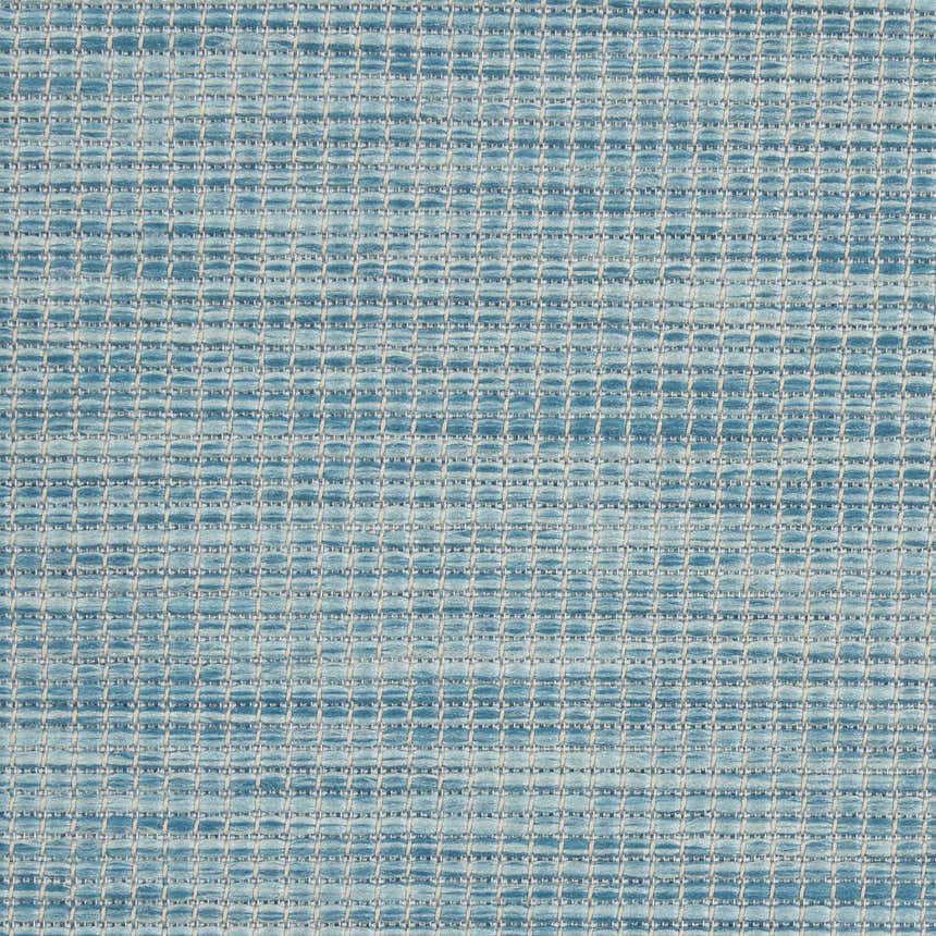 Close-up of the Nourison Positano Aqua rug, showing its woven texture and grid-like pattern in shades of blue and white.