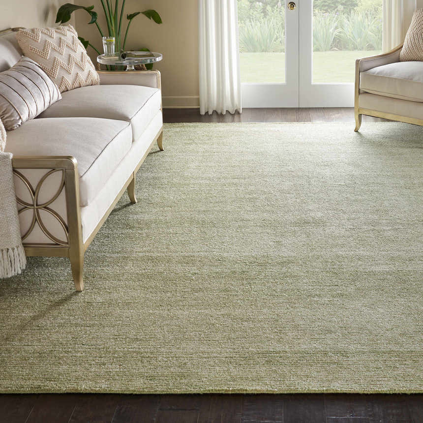 Living room scene with a Nourison Weston Citron rug, cream sofa, and natural light from the garden.