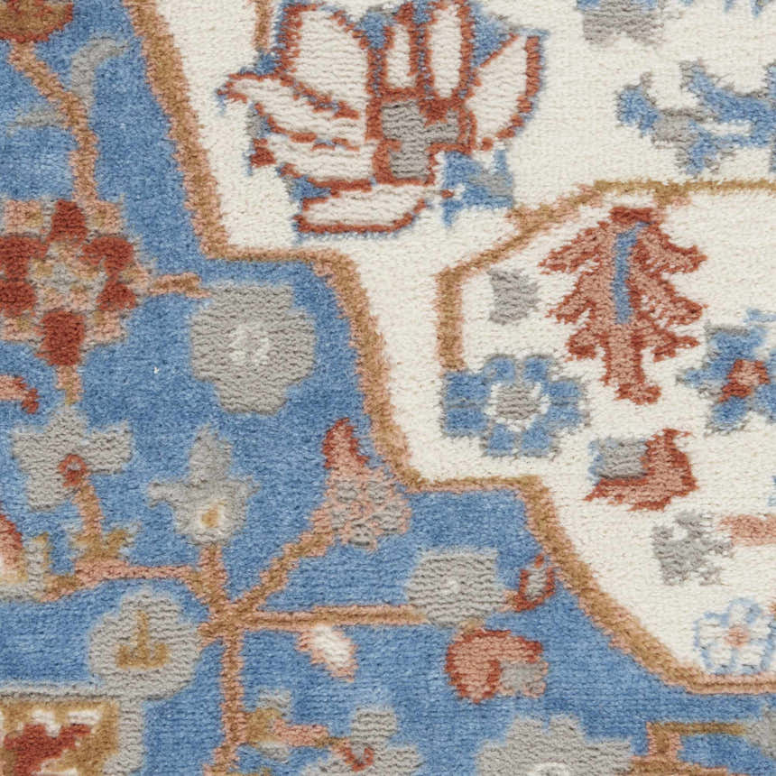 Close-up of the Nourison Elation Ivory Blue rug. High pile texture with chestnut, blue, and ivory floral pattern.