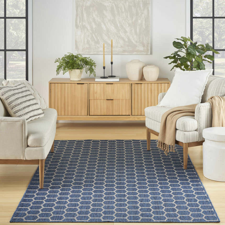 Modern living room with a light wood console and the blue Nourison Twist Reversible Area Rug.