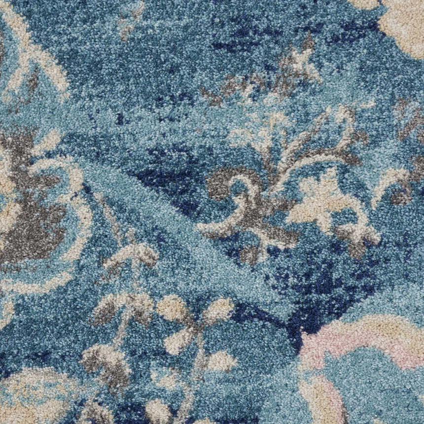Close-up of the Nourison Tranquil Turquoise Vintage rug. Aqua, beige, and gray floral pattern, textured polypropylene.
