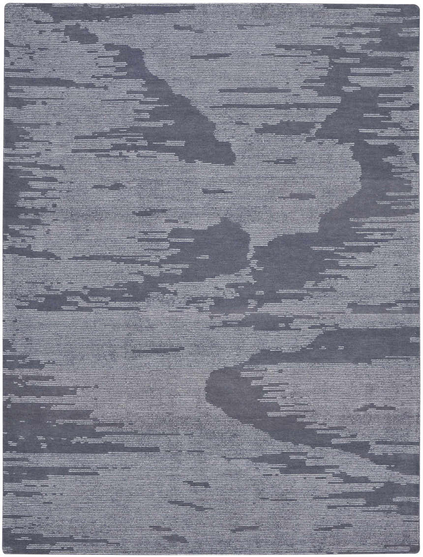 Close-up of the Michael Amini Ma30 Star Blue rug. Modern wool rug with abstract light blue pattern. Handmade texture.