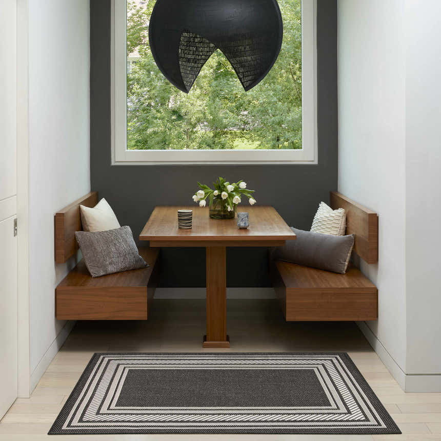 Breakfast nook with wood benches and Nourison Horizon Black Modern Area Rug.