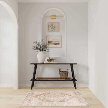 Hallway with a Nourison Astra Beige Vintage rug, console table, art, and light wood floors.