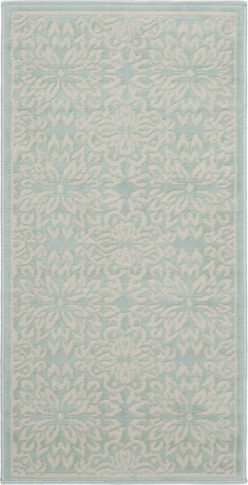 Close-up of the Nourison Jubilant Ivory Green rug, showcasing its floral pattern and soft, farmhouse style.