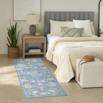 Farmhouse bedroom scene with blue floral Nourison Botanical runner rug, wood floors, and neutral decor.