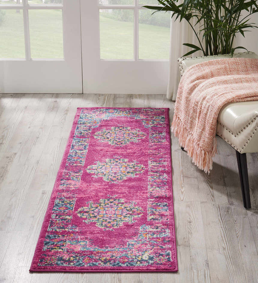 Entryway with Nourison Passion Fuchsia Bohemian rug, light wood floors, white door, and bench with pink throw.